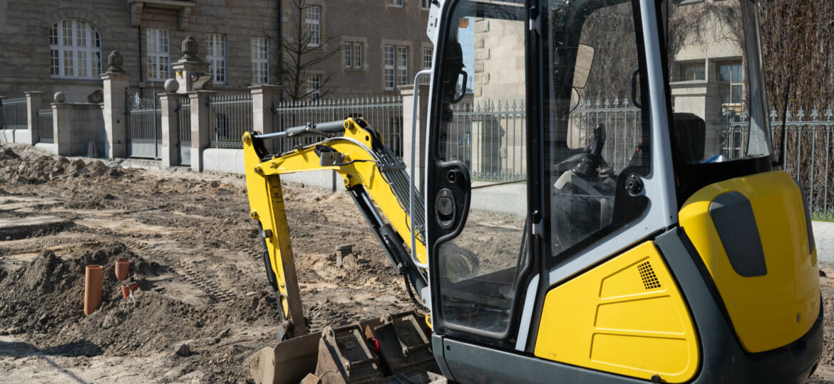 Construction Excavator Performs Road Repair Work
